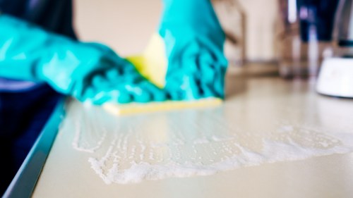 Deep carpet cleaning equipment in use on a hallway rug